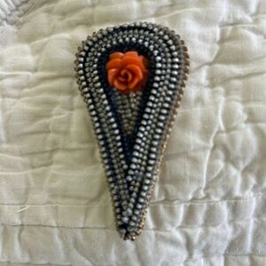 Unique handmade brooch from zippers and coral. Wood support. Fun!